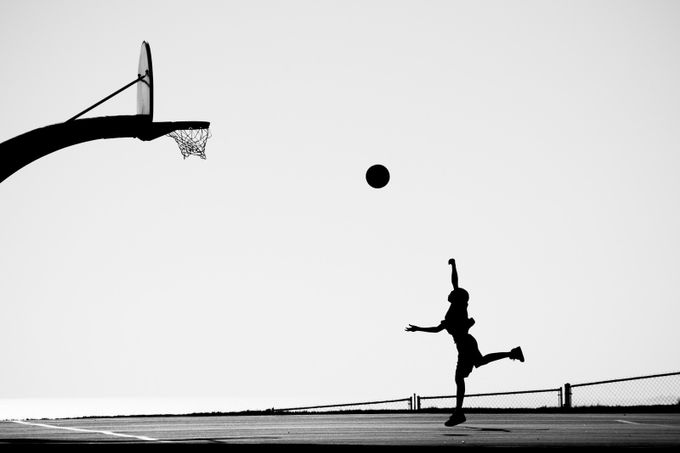 Boy playing basketball by manueladurson - Silhouettes In The City Photo Contest