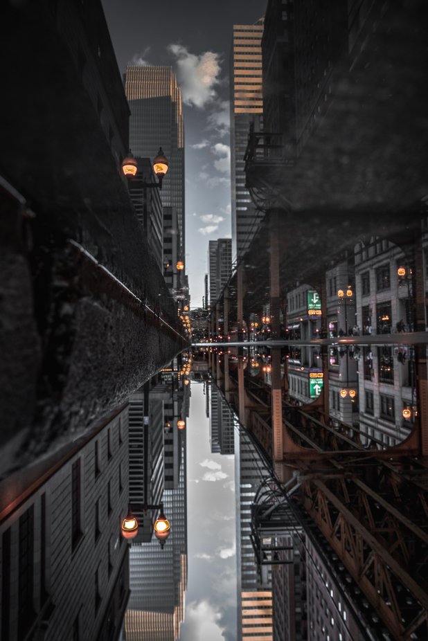 The week I was in Chicago there were a couple of rainy days. As I was walking through the city this puddle just caught my eye with the view it had in front of it. The reflection was perfect since the water was still.  by williamdunn_9877 - Urban Captures Photo Contest
